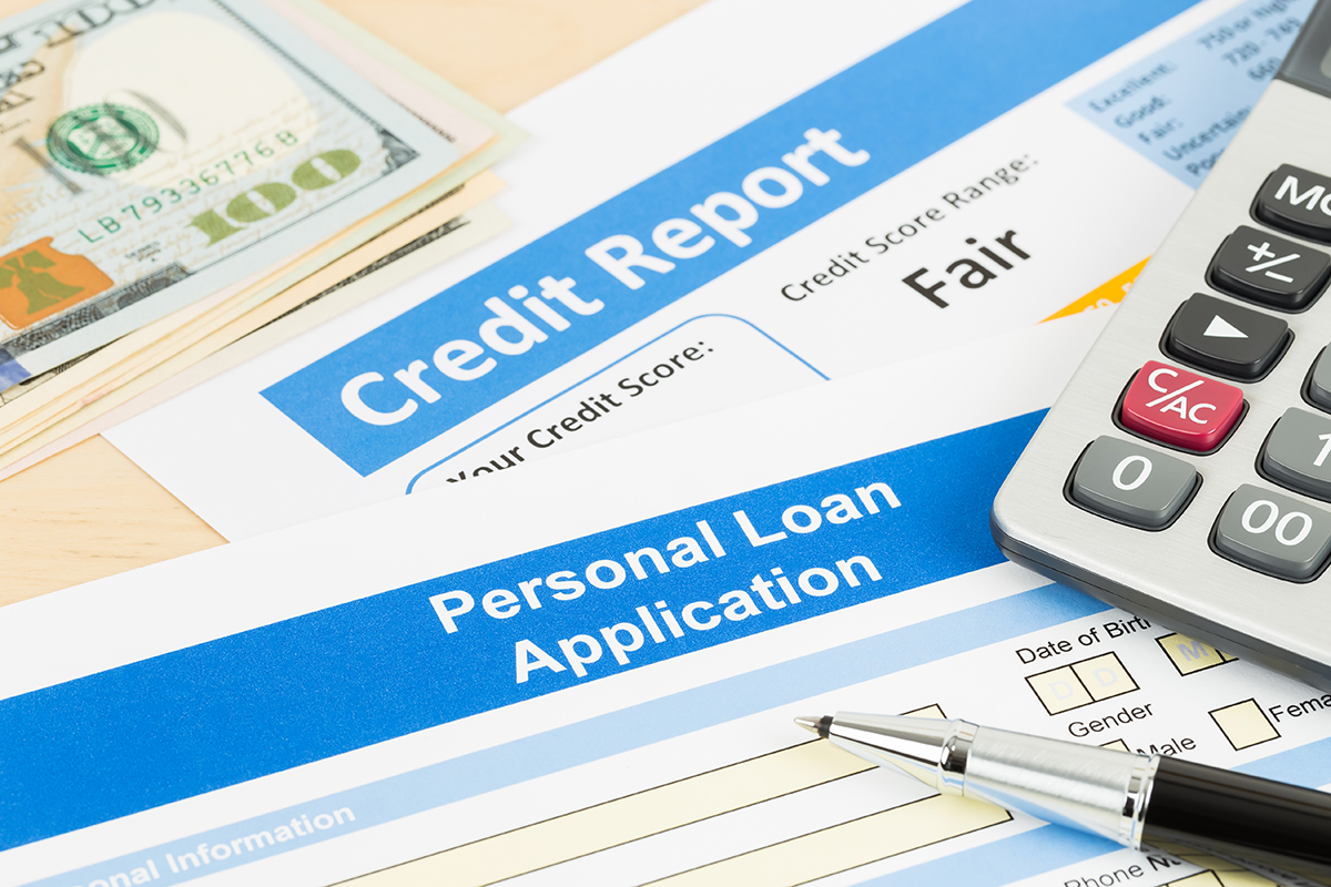Personal loan application, credit report, and banknotes.