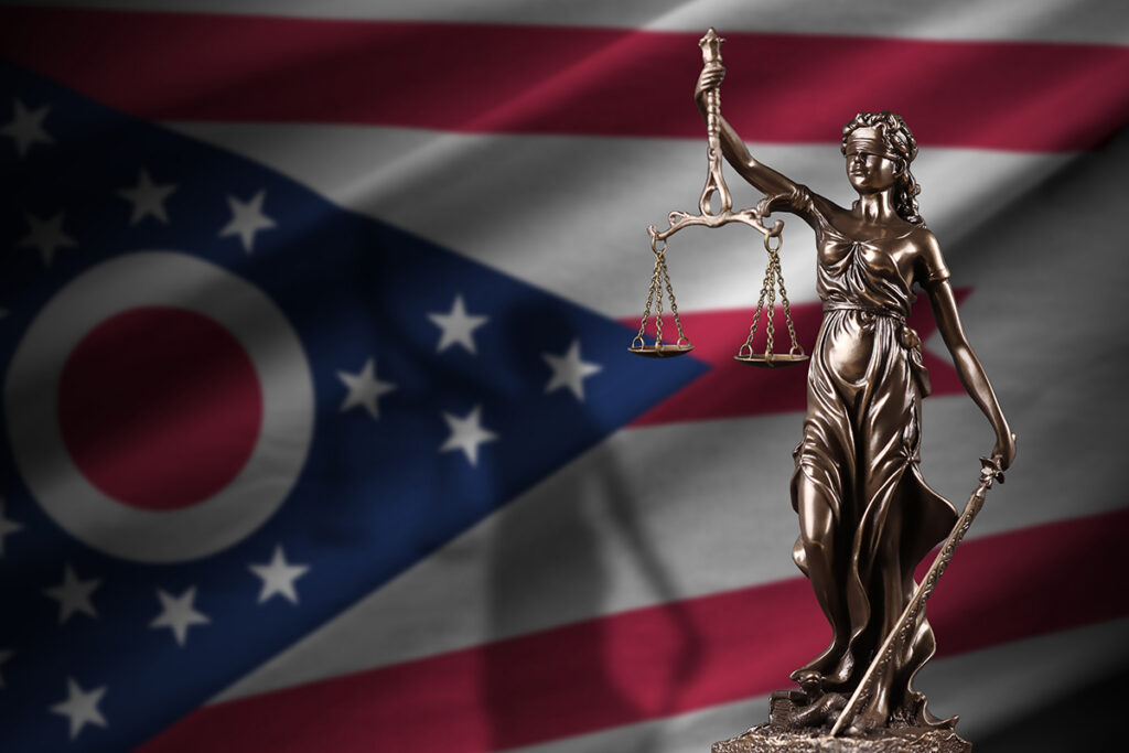 Ohio state flag and lady justice statue
