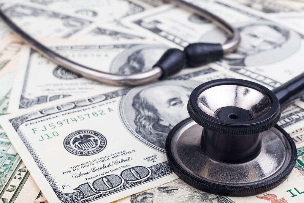 stethoscope on money signifying medical debt