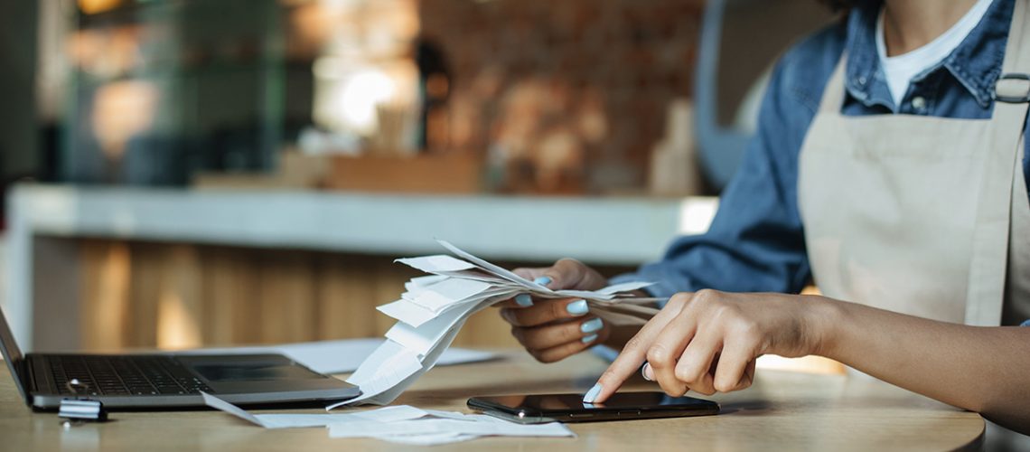 Business owner works with financial bills.